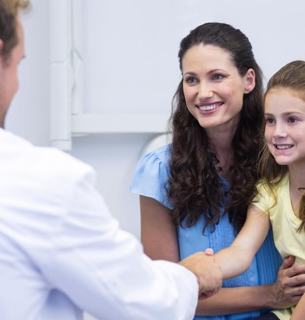 Smiling mother and daughter speaking with Viva Dental Dentist