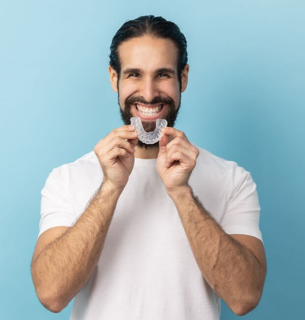 Smiling patient with his Invisalign