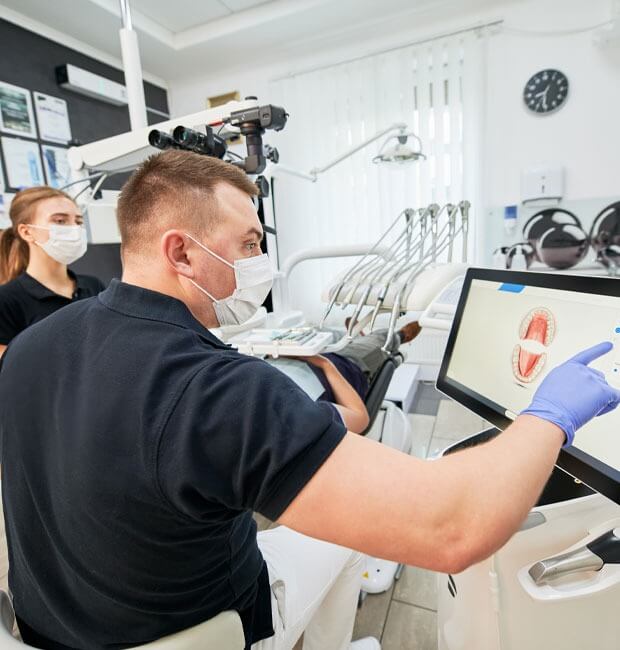 Dentist reviewing a patient's teeth x-ray for oral cancer