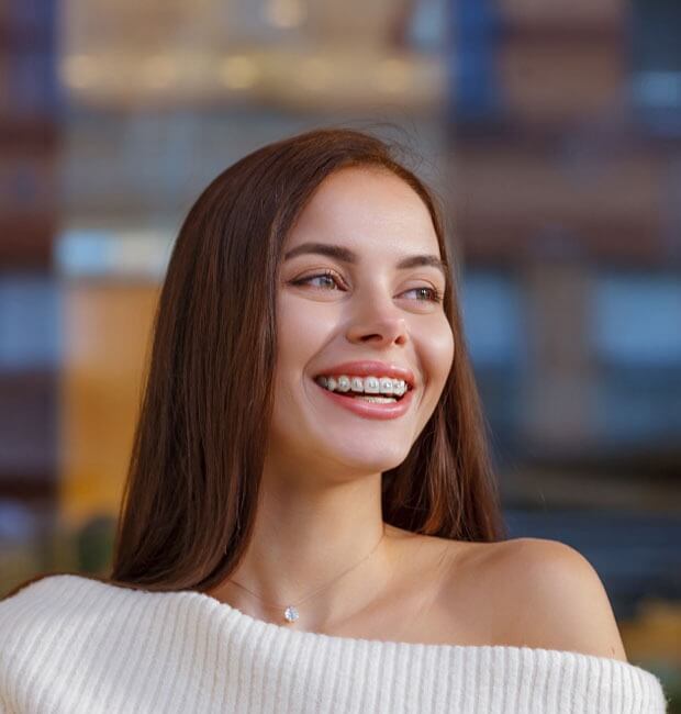 Smiling female patient with adult braces