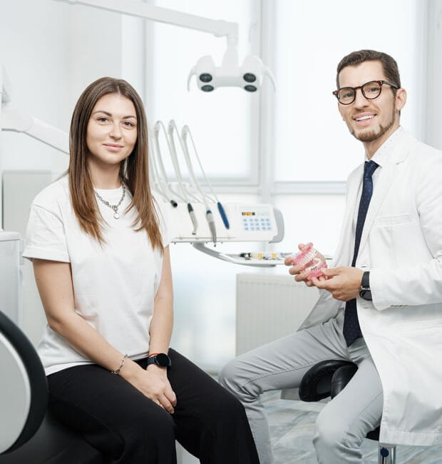 Dentist explaining to a patient the ways to fix her TMJ issues