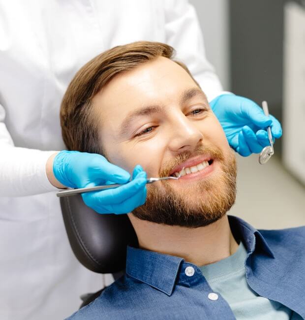 Patient having his teeth whiten by dentist